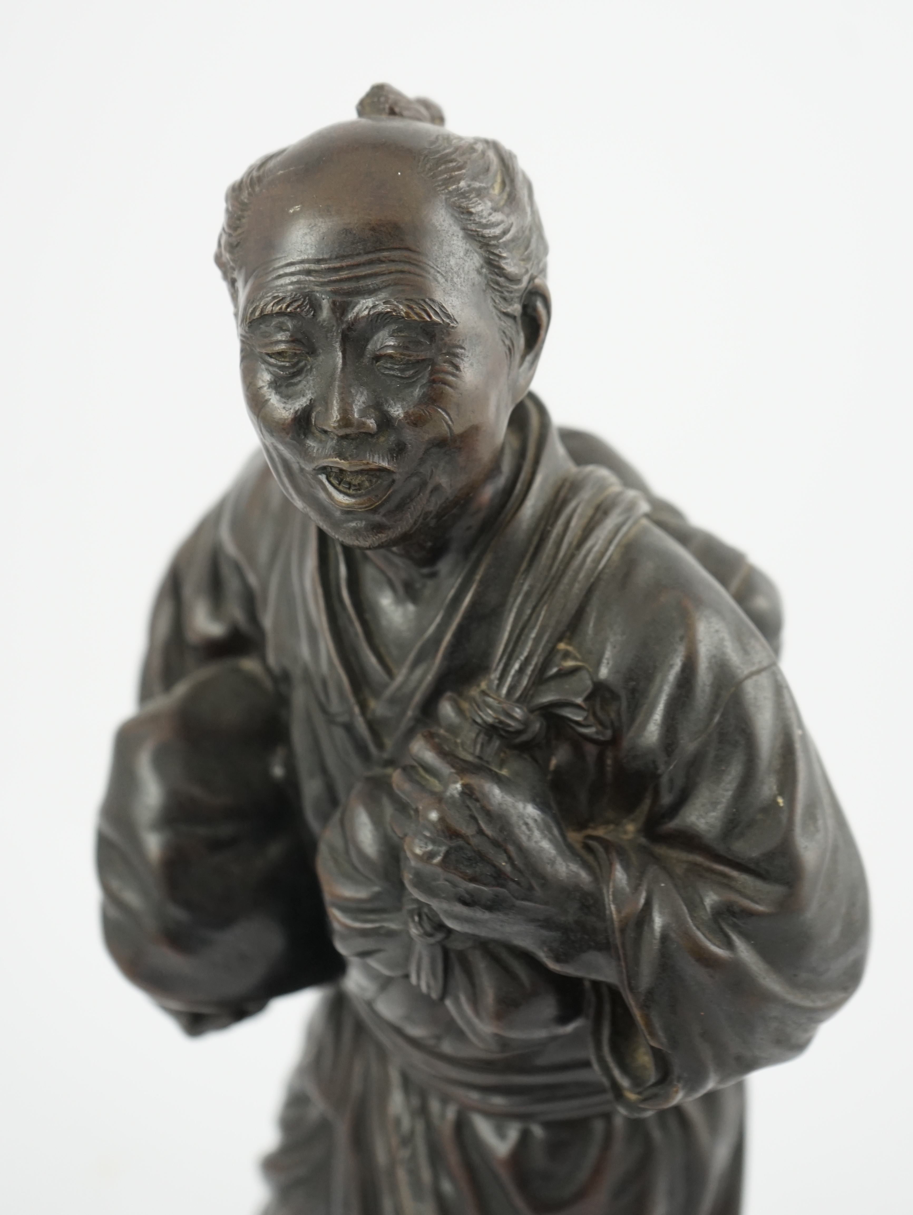 A Japanese bronze figure of a man, 19th century